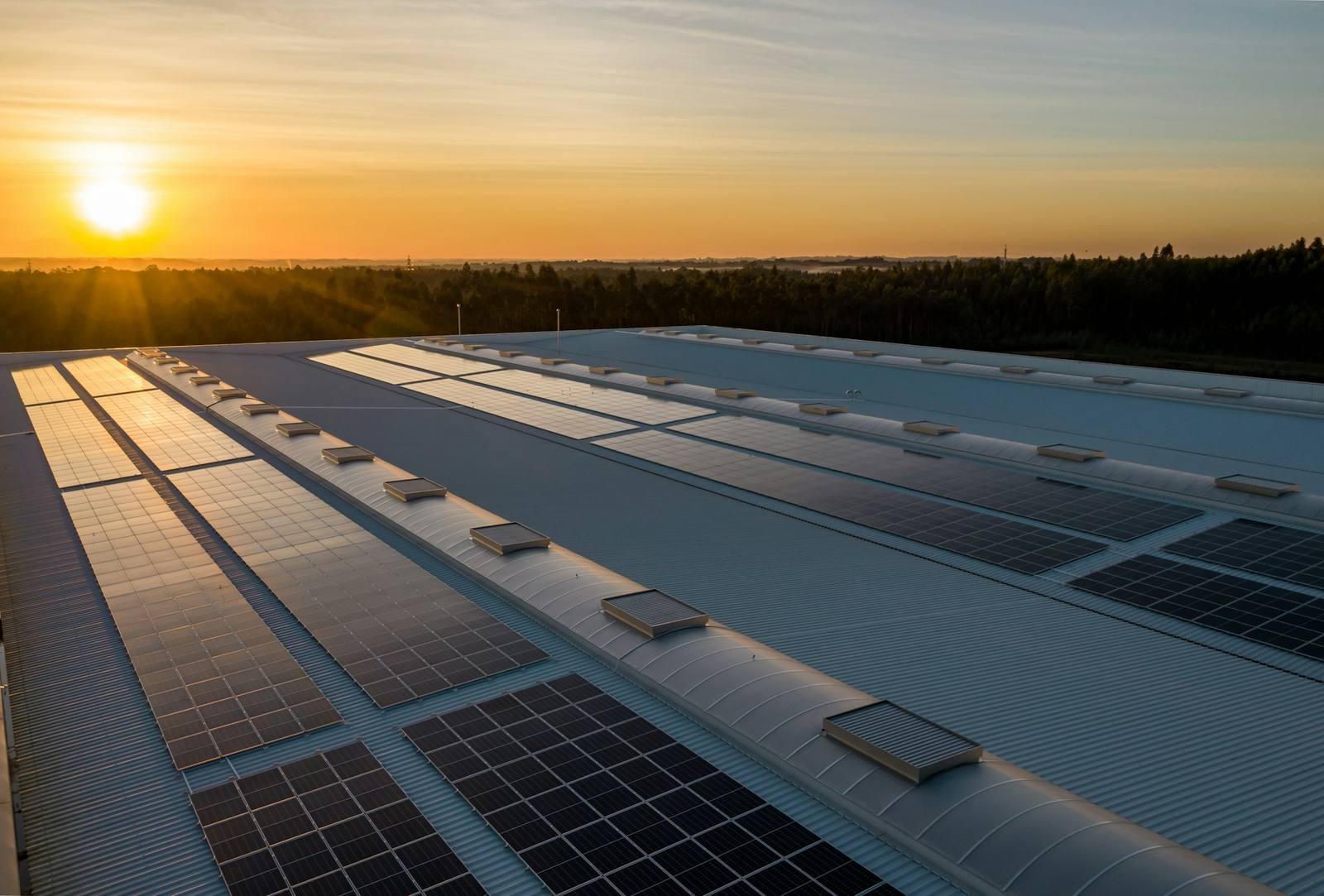 Rooftop solar panels at sunset with clouds