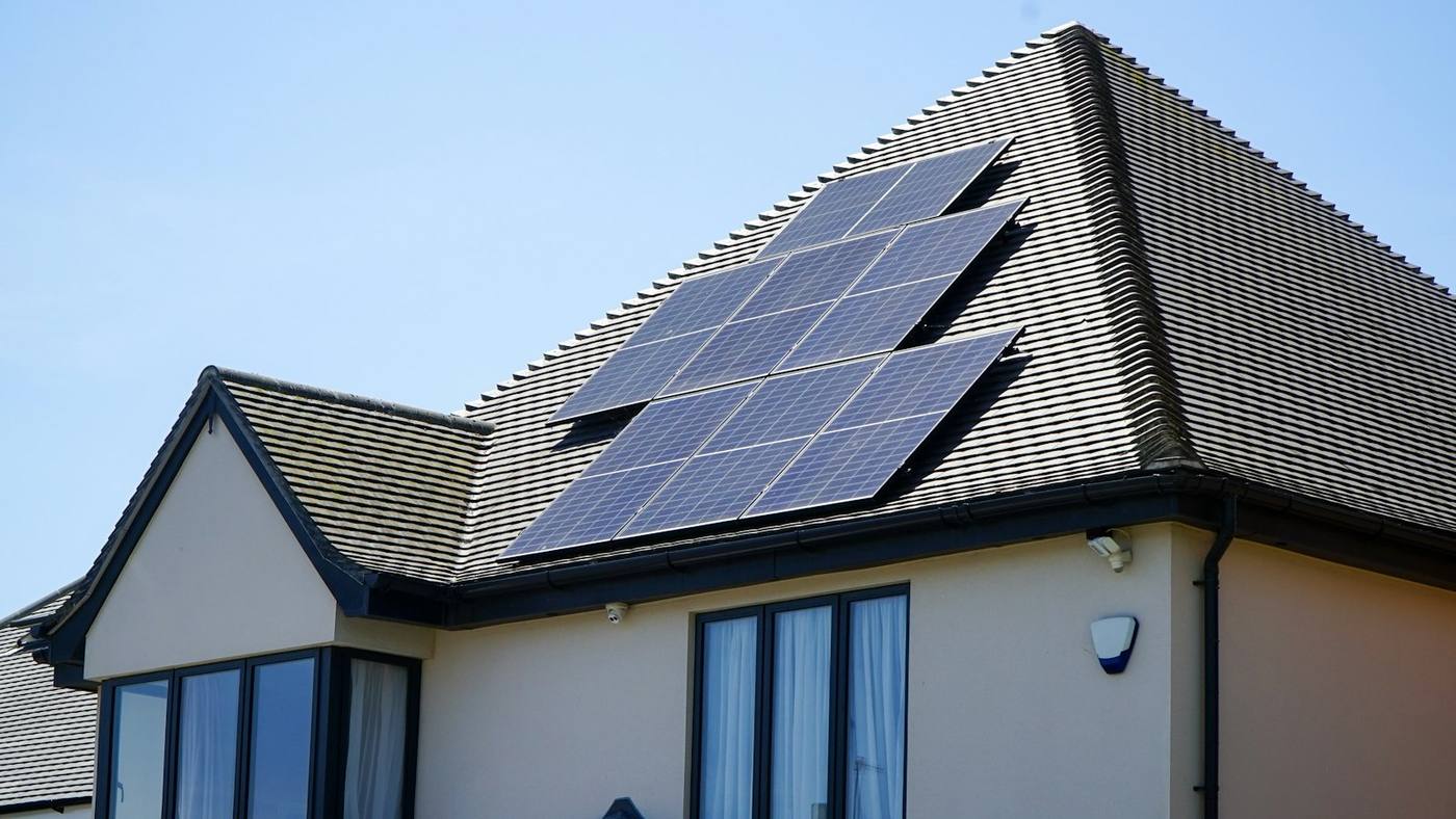 Home with rooftop solar panels under a clear sky in Tamil Nadu